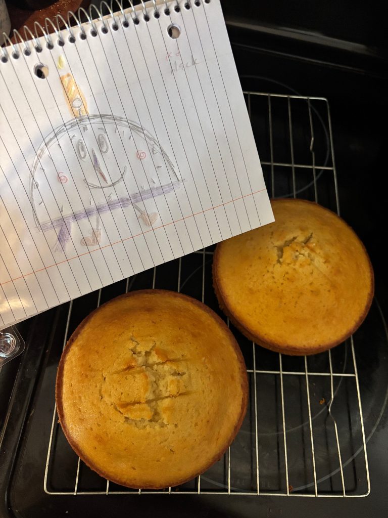 A sketch of Tallo's mascot, in front of cake in the oven