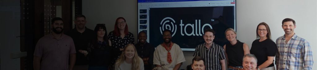 The Tallo team standing in an office room and powerpoint screen with the Tallo logo