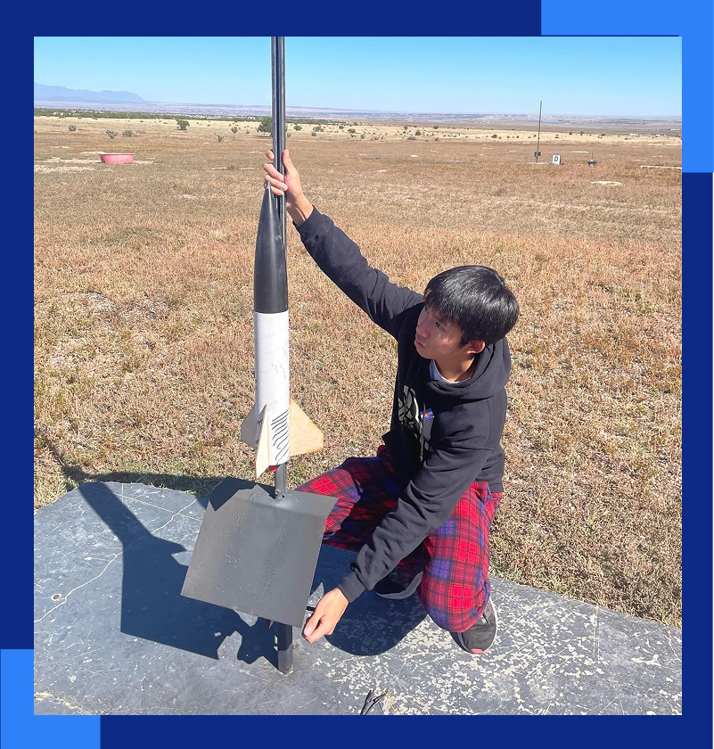 Ryan C, student, preparing to launch a homemade rocket