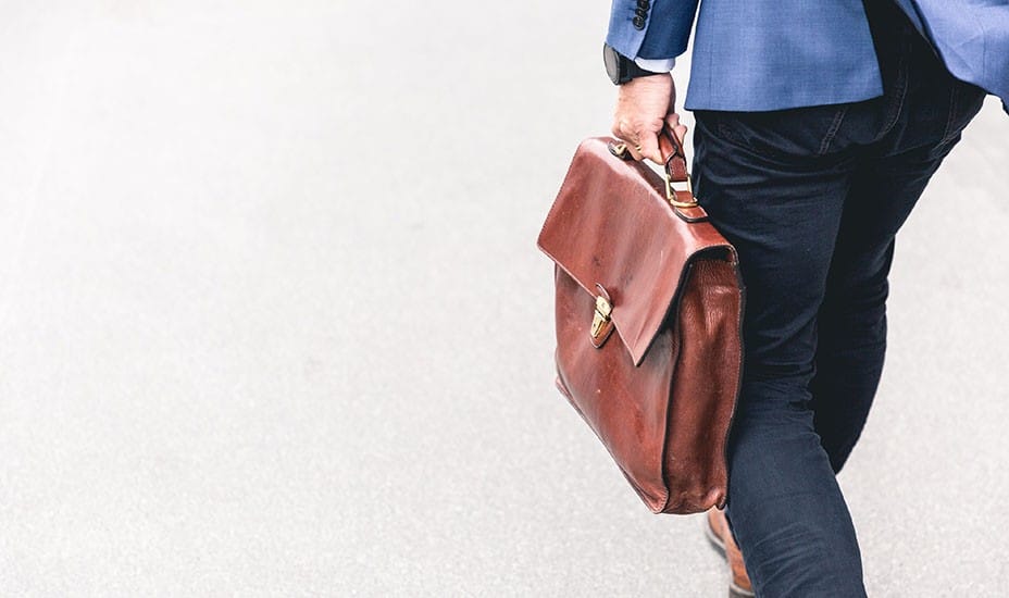 student walking to work with a briefcase