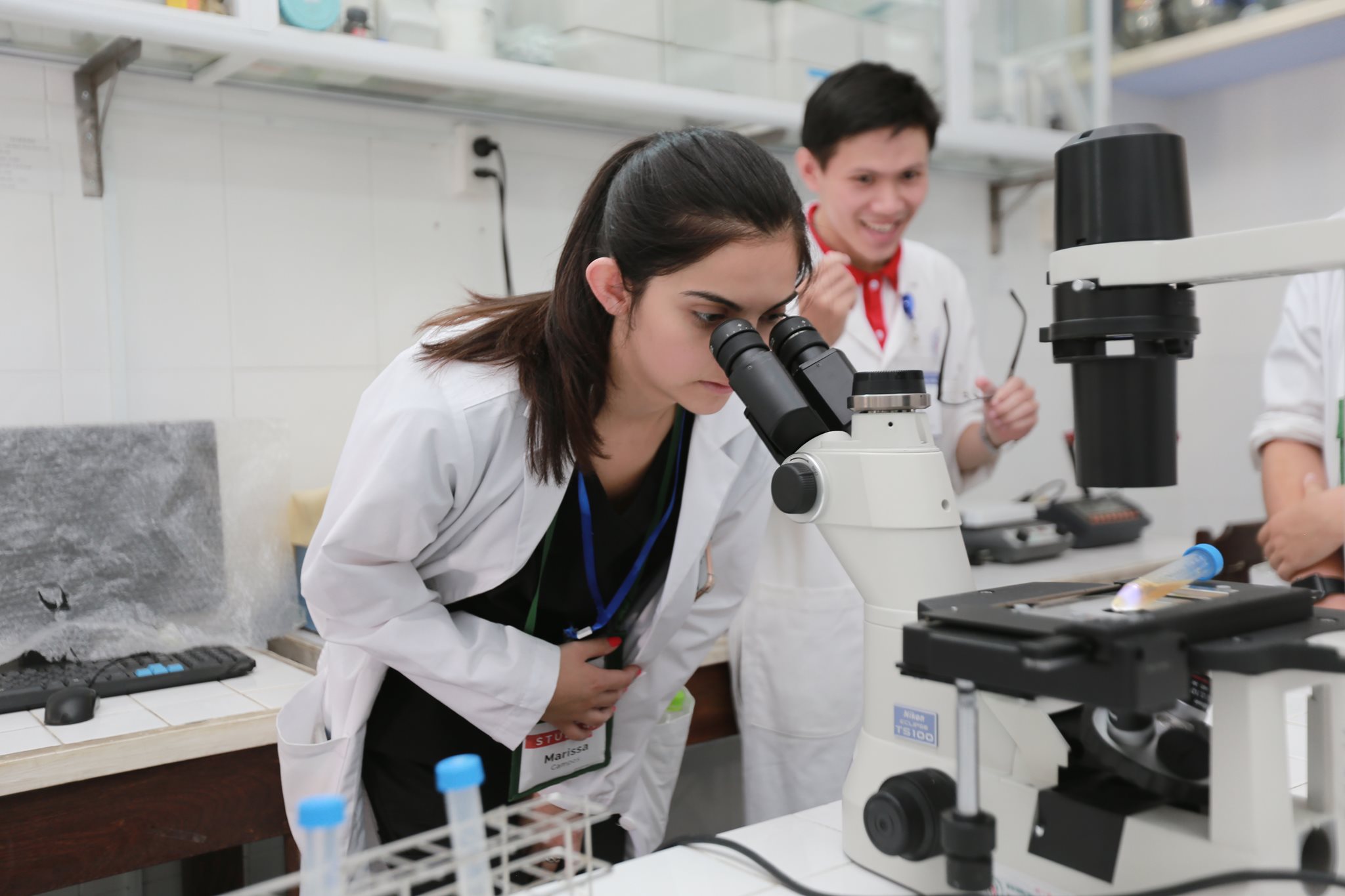 girl looking in microscope