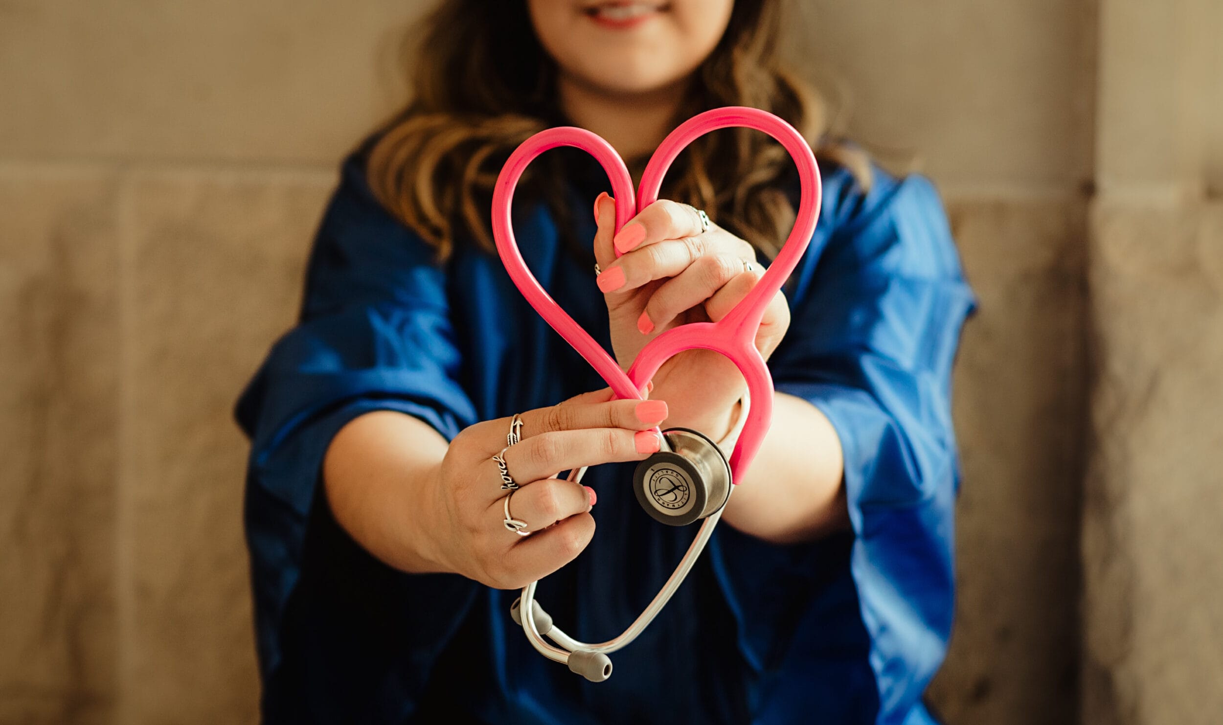 Nurse making heart with doctor tool