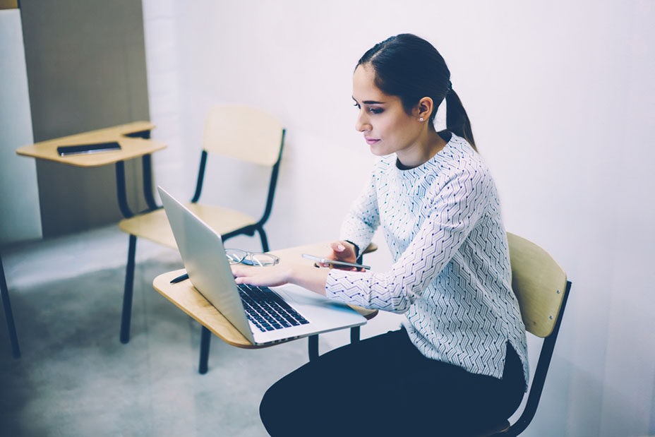 Student typing on laptop